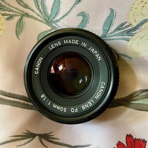 Canon FD 50mm f/1.8 lens with UV filter and drawstring lens bag